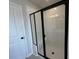 Modern shower with a black-framed glass door and white tiled walls, offering a sleek and clean design at 5124 Double Eagle, Summerville, SC 29485