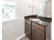 Bathroom showcasing a granite countertop with wood cabinets, a modern sink, and a window view at 522 Truman Dr, Goose Creek, SC 29445