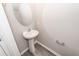 Small powder room featuring a pedestal sink, an oval mirror, a towel rack, and wood-look flooring at 522 Truman Dr, Goose Creek, SC 29445