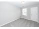 This cozy bedroom features neutral carpet, a window, and plenty of natural light at 522 Truman Dr, Goose Creek, SC 29445