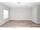Spacious bedroom featuring neutral paint, wood-look floors, a large window, and ample closet space at 522 Truman Dr, Goose Creek, SC 29445