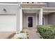 A close-up of the front door of the townhome, set back from the attached garage, with a small stoop at 522 Truman Dr, Goose Creek, SC 29445