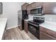 Modern kitchen with stainless steel appliances, countertops, and dark wood cabinets at 522 Truman Dr, Goose Creek, SC 29445