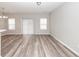 Open-concept living room featuring wood-look floors, neutral paint, and sliding glass doors to the backyard at 522 Truman Dr, Goose Creek, SC 29445