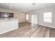 Open-concept living room flows into the kitchen and dining area, with wood-look floors and modern finishes at 522 Truman Dr, Goose Creek, SC 29445