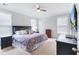 Comfortable bedroom with carpet floors, a ceiling fan, and two large windows for natural light at 532 Fern Tree Dr, Summerville, SC 29486