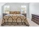 Bedroom featuring two windows, two bedside tables with lamps, and an ornate comforter at 532 Fern Tree Dr, Summerville, SC 29486