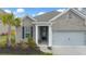 Close-up of a charming brick home featuring a well-manicured lawn and covered entrance at 532 Fern Tree Dr, Summerville, SC 29486