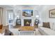 Cozy living room with a fireplace, hardwood floors, and an open layout to other areas of the home at 532 Fern Tree Dr, Summerville, SC 29486