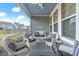 Inviting covered patio with comfortable seating, a ceiling fan, and a view of the backyard at 532 Fern Tree Dr, Summerville, SC 29486