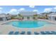 A pristine pool with a clubhouse, lounge chairs and shade pergolas at 532 Fern Tree Dr, Summerville, SC 29486