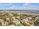 Picturesque aerial view of a coastal neighborhood near the beach and bay, surrounded by trees and lush landscape at 65 Ocean Point Dr, Isle of Palms, SC 29451