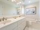Bright bathroom featuring double vanity with a marble countertop and framed mirror above at 65 Ocean Point Dr, Isle of Palms, SC 29451