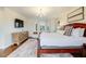 Bedroom with a king-size bed, hardwood floors, shuttered windows, a dresser, and a TV at 65 Ocean Point Dr, Isle of Palms, SC 29451