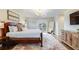Bright bedroom features a king-size bed, hardwood floors, a dresser, and access to a balcony at 65 Ocean Point Dr, Isle of Palms, SC 29451