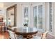Breakfast nook area with a round table, chairs, white plantation shutters, and luxury hardwood flooring at 65 Ocean Point Dr, Isle of Palms, SC 29451