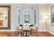 Dining area features a modern floor lamp and a wood table with white chairs under a bay window at 65 Ocean Point Dr, Isle of Palms, SC 29451
