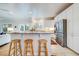 Modern kitchen featuring stainless appliances, granite countertops, white cabinetry, and barstool seating at 65 Ocean Point Dr, Isle of Palms, SC 29451