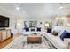 Bright living room featuring hardwood floors, ceiling fans, comfortable seating, and plenty of natural light at 65 Ocean Point Dr, Isle of Palms, SC 29451