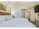 Bedroom with a four-poster bed, hardwood floors, and access to the hallway at 65 Ocean Point Dr, Isle of Palms, SC 29451