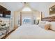 Bright bedroom with vaulted ceilings, a four-poster bed, and a door to a balcony at 65 Ocean Point Dr, Isle of Palms, SC 29451