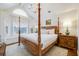 Spacious bedroom features vaulted ceilings, a four-poster bed, and a window seat with abundant natural light at 65 Ocean Point Dr, Isle of Palms, SC 29451