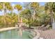 Inviting pool area featuring lounge chairs, a dining set, and well-manicured landscaping for outdoor gatherings at 65 Ocean Point Dr, Isle of Palms, SC 29451
