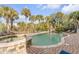Gorgeous backyard pool and jacuzzi surrounded by an inviting brick patio and lush tropical landscaping at 65 Ocean Point Dr, Isle of Palms, SC 29451