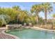 Relaxing pool area with a spa, lounge chairs, and lush tropical landscaping for ultimate outdoor enjoyment at 65 Ocean Point Dr, Isle of Palms, SC 29451