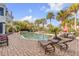 Backyard pool with hot tub, patio, lounge chairs, and a dining area surrounded by lush greenery at 65 Ocean Point Dr, Isle of Palms, SC 29451