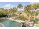 Backyard pool and spa with beautiful landscaping and outdoor dining area at 65 Ocean Point Dr, Isle of Palms, SC 29451