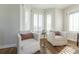 Sitting area features two comfortable chairs, a small table, hardwood floors, and shuttered windows at 65 Ocean Point Dr, Isle of Palms, SC 29451