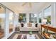 Bright sunroom with lots of windows and neutral décor, showcasing a comfortable seating area at 65 Ocean Point Dr, Isle of Palms, SC 29451