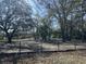 Large backyard with mature trees and fencing, perfect for outdoor activities at 651 Magnolia Rd, Charleston, SC 29407
