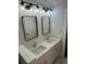 The bathroom features dual sinks, marble countertops, modern lighting and hardware at 651 Magnolia Rd, Charleston, SC 29407