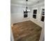 Spacious dining area with natural light, hardwood flooring and chandelier at 651 Magnolia Rd, Charleston, SC 29407