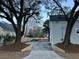 Wide driveway surrounded by trees and landscaping leading up to the side of the home at 651 Magnolia Rd, Charleston, SC 29407