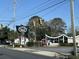 Street view of the East Bay Deli restaurant building with an architectural roof and a black sign on a sunny day at 651 Magnolia Rd, Charleston, SC 29407