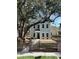 Charming two-story home with new paint, black trim windows, black fence and a beautiful mature tree at 651 Magnolia Rd, Charleston, SC 29407