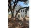 Charming two-story home with new paint, black trim windows, black fence and a beautiful mature tree at 651 Magnolia Rd, Charleston, SC 29407