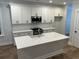 Stylish kitchen featuring white cabinets, stainless steel appliances, and a quartz countertop island at 651 Magnolia Rd, Charleston, SC 29407