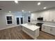 Bright kitchen features white cabinets, stainless appliances, and a center island with quartz countertop at 651 Magnolia Rd, Charleston, SC 29407