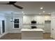 Modern kitchen with white cabinets, island, stainless steel appliances, and recessed lighting at 651 Magnolia Rd, Charleston, SC 29407