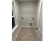 A laundry room featuring tile flooring and shelving for ample storage solutions at 651 Magnolia Rd, Charleston, SC 29407