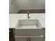 The kitchen features a farmhouse style sink with quartz countertops and white cabinets at 651 Magnolia Rd, Charleston, SC 29407