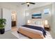 A beautifully staged bedroom with a bed, ensuite bathroom, and plant accent at 715 Rumbling Leaf Ln, Summerville, SC 29486
