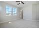 Bright bedroom with plush carpeting, a ceiling fan, and two windows providing natural light at 715 Rumbling Leaf Ln, Summerville, SC 29486