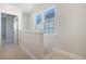 Bright hallway featuring plush carpeting, natural light from windows, and white trim details at 715 Rumbling Leaf Ln, Summerville, SC 29486