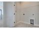 A well-lit laundry room with tile floors, wire rack shelving, and connections for washer and dryer at 715 Rumbling Leaf Ln, Summerville, SC 29486