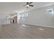 Open-concept living area with a kitchen island, white cabinets, and wood grain floors. Lots of natural light at 715 Rumbling Leaf Ln, Summerville, SC 29486